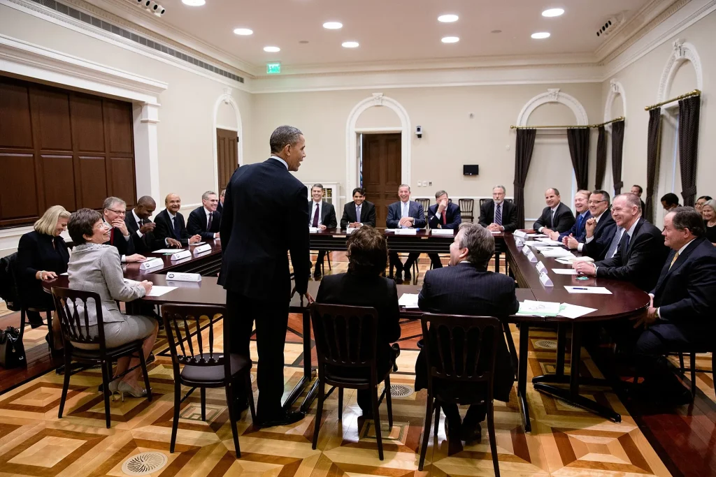 Global Firms Rethink AI Budgets as Bubble Warnings Grow Louder Chief executives seated around a table at a business roundtable meeting
