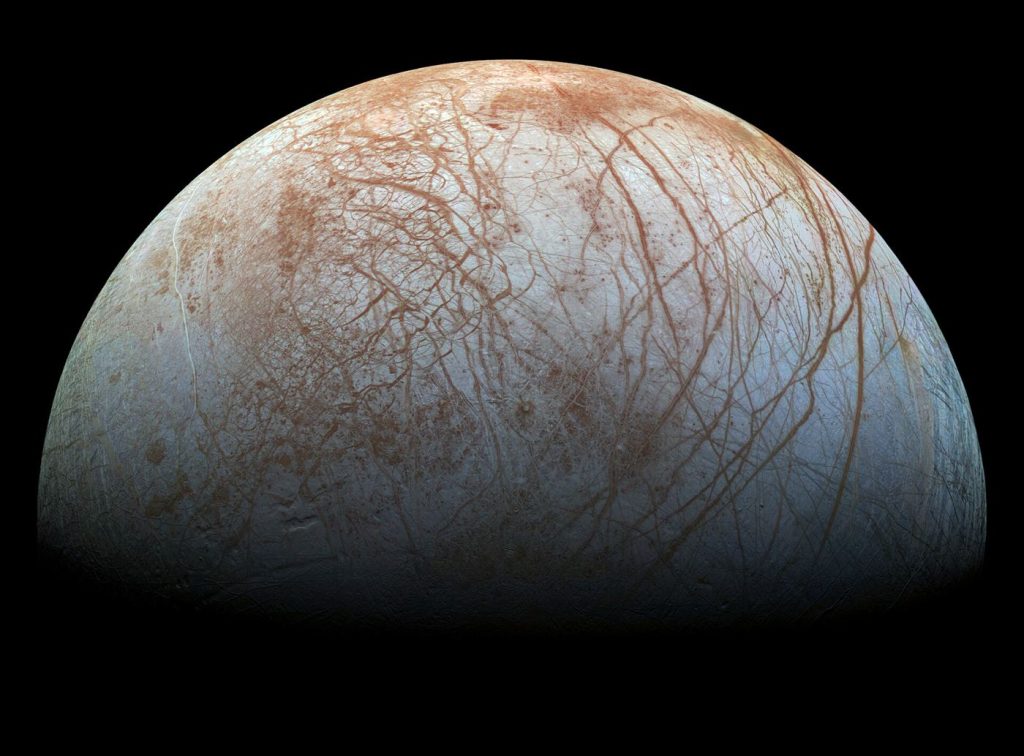 Mission Teams Hunt for Plumes Venting From Europa’s Ocean Europa's fractured icy surface seen against the blackness of space