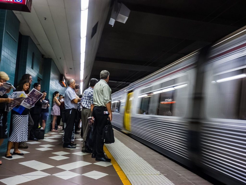 Commuters waiting on a busy train station platform