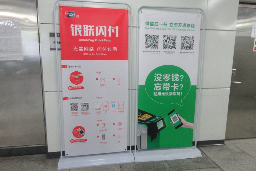 Central Bank Digital Currencies Reach an Awkward Adolescence A person paying with a smartphone at a shop counter